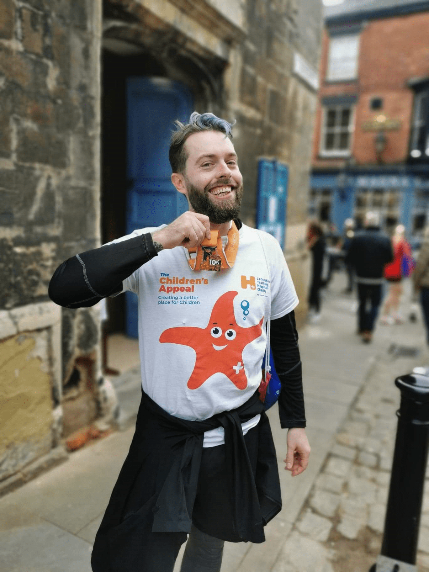 Photo of Lucke Jackson - smiling, wearing a Charity t-shirt