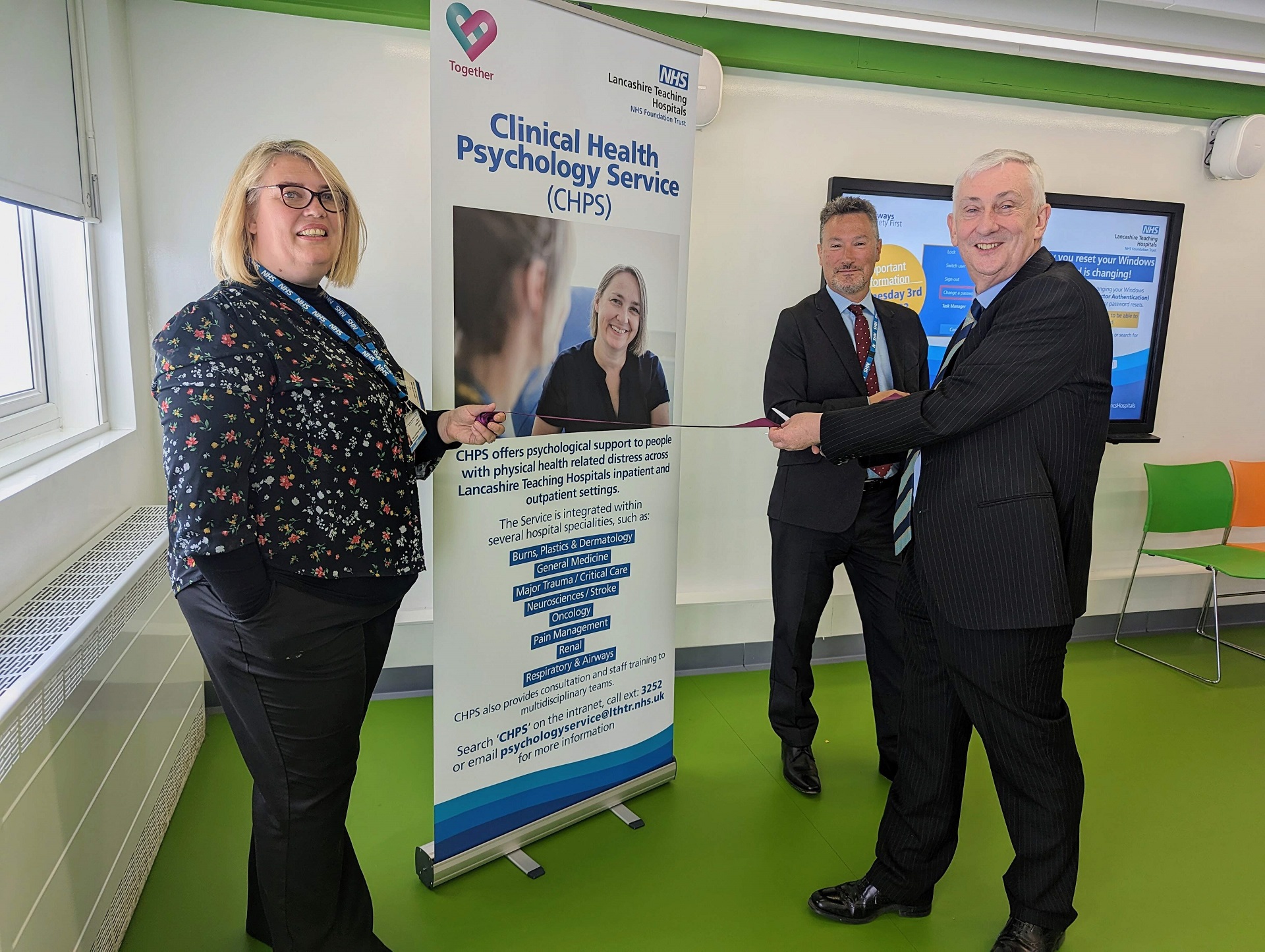 Sir Lindsay Hoyle cuts a ribbon in front of a Psychology Service vertical banner.