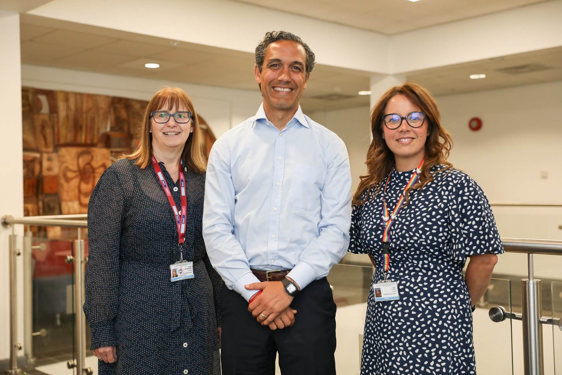 A professional photo depicting three smiling NHS staff members