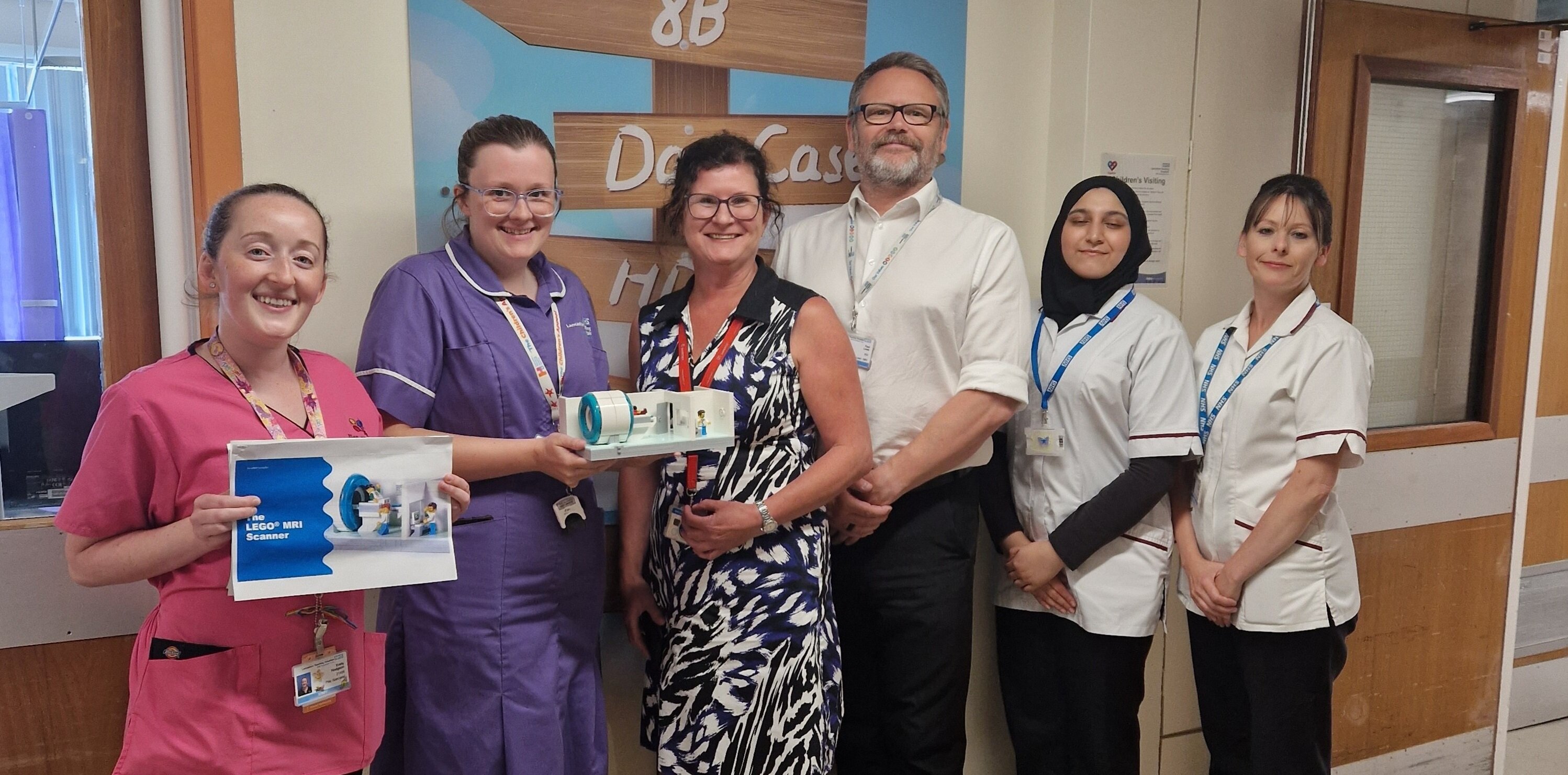 Lancashire Teaching Hospitals staff pictured holding a LEGO toy