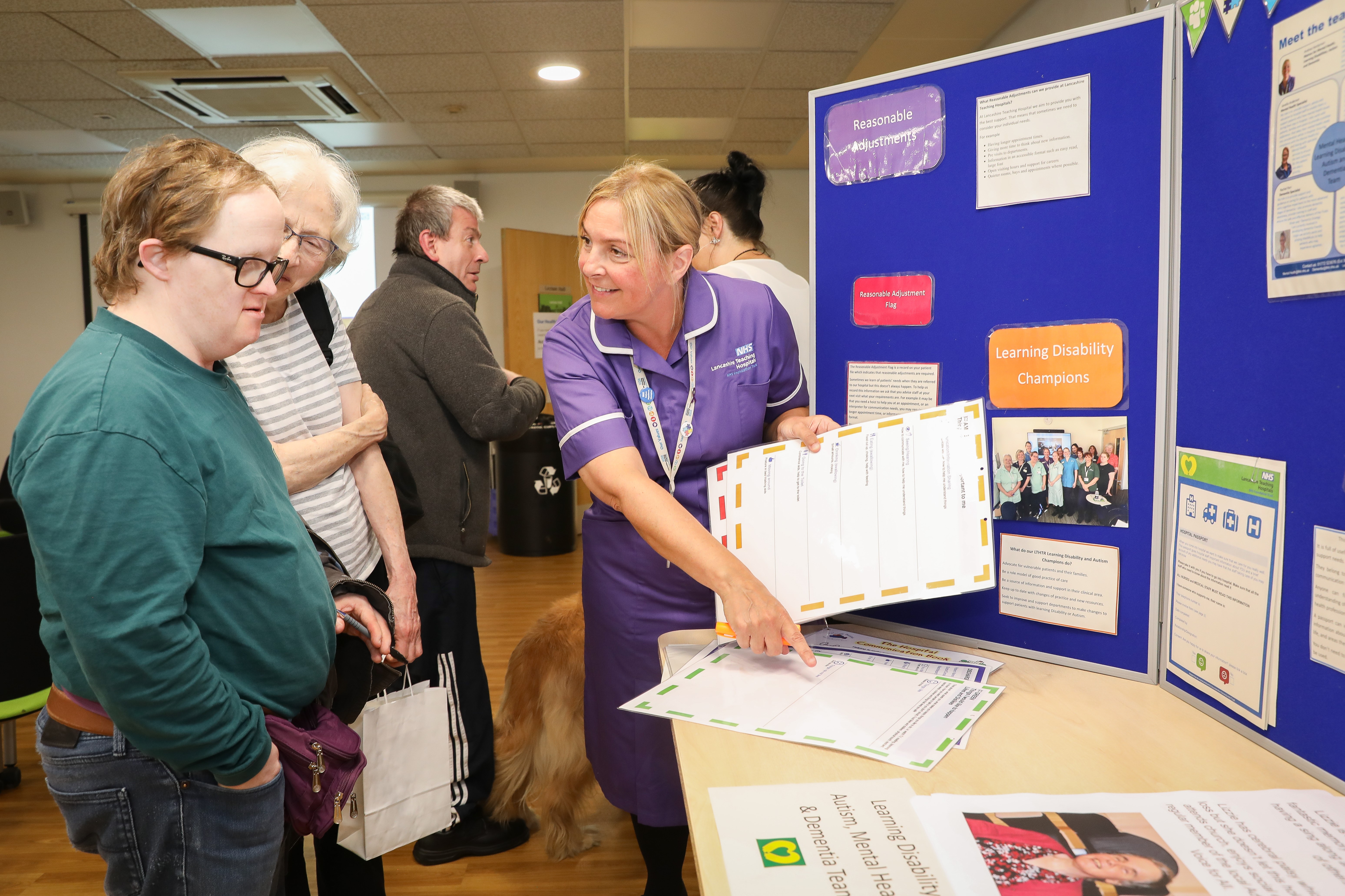 NHS staff member showcasing information to patients and visitors