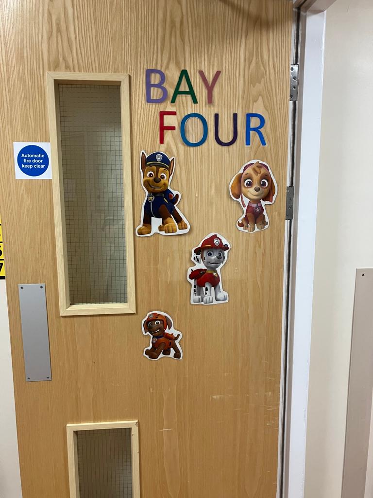 Image of door children's cartoon paper cutouts, plastered on the door