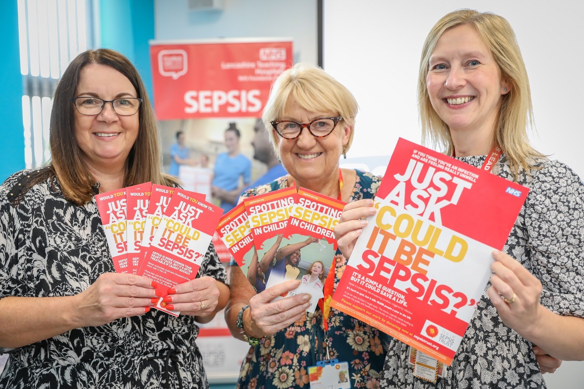 People holding sepsis awareness leaflets