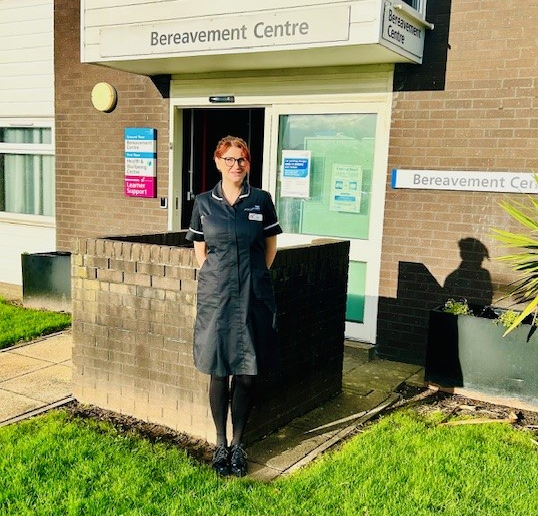 Photo of Amy Ashworth standing in front of the Bereavement Centre's entrace