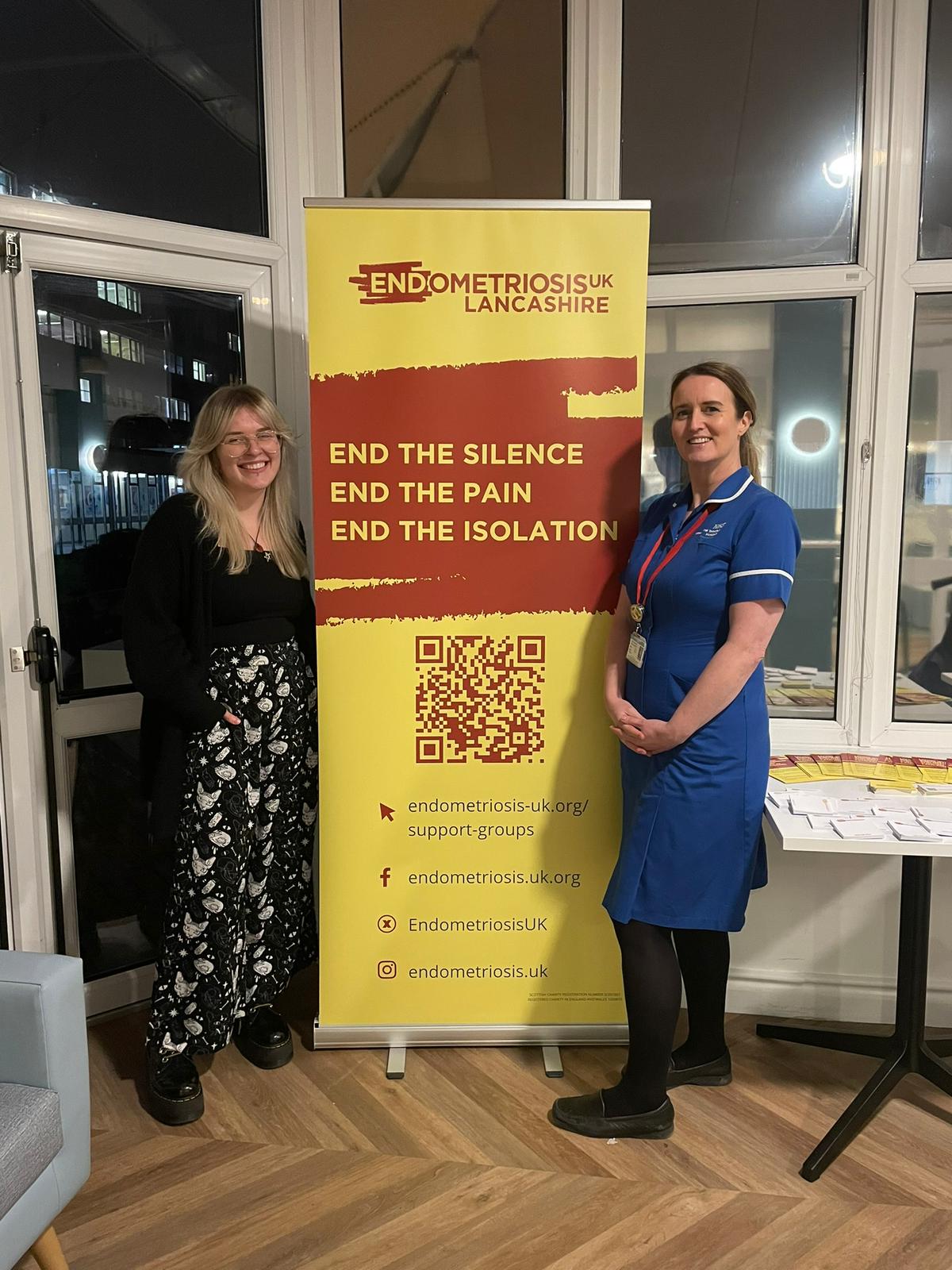 Photo of NHS staff members next to Endometriosis UK Lancashire banner