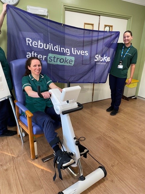 A photo of an NHS professional using a cardio machine, while two other NHS professionals hold a 'Stroke' flag which reads 'Rebuilding lives after stroke'
