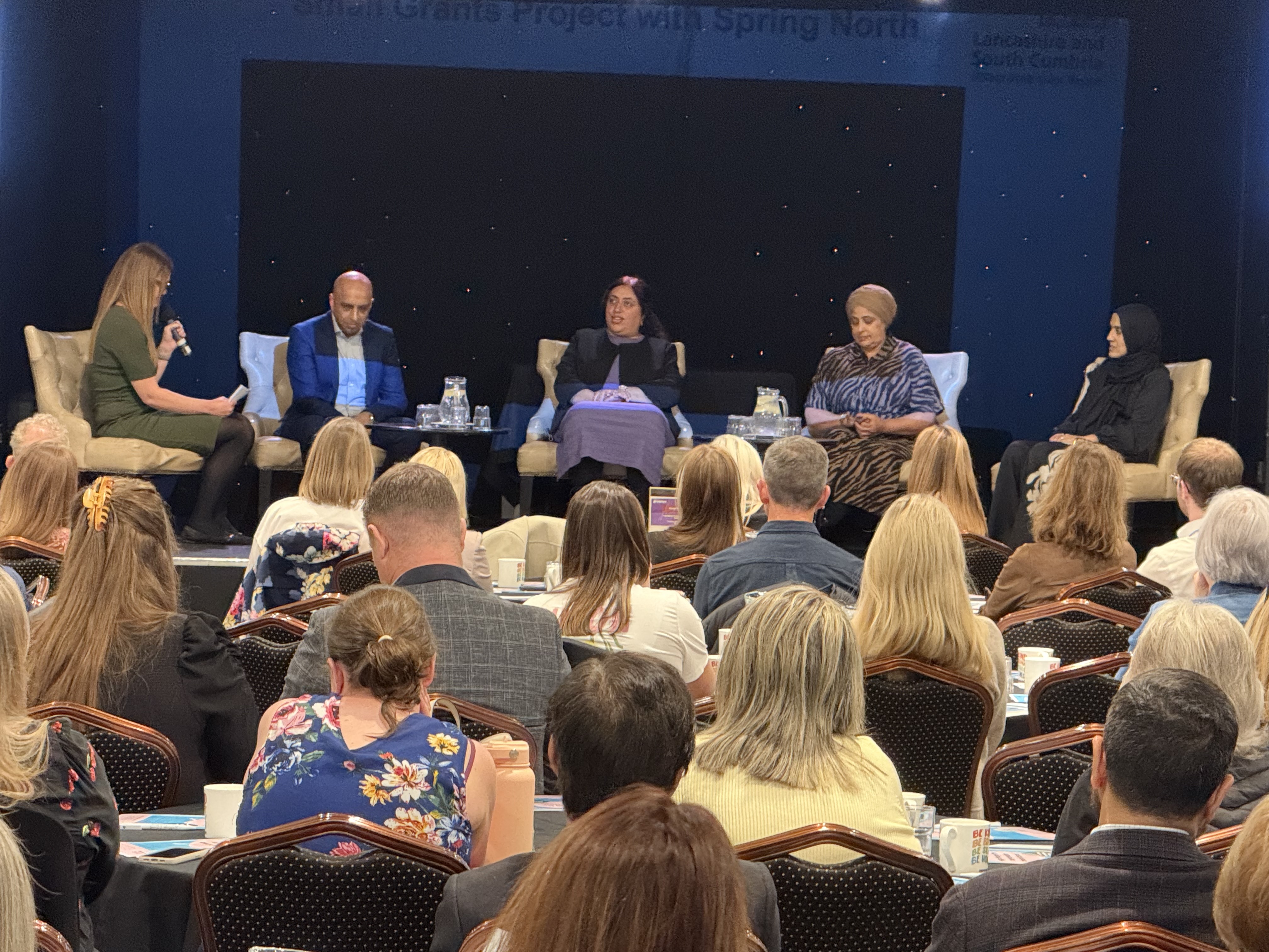 A photo of the conference hosts alongside with the attendees