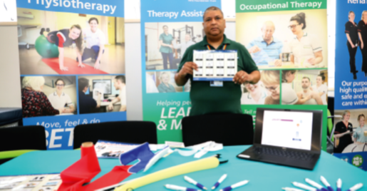 a member of staff infront of therapy information
