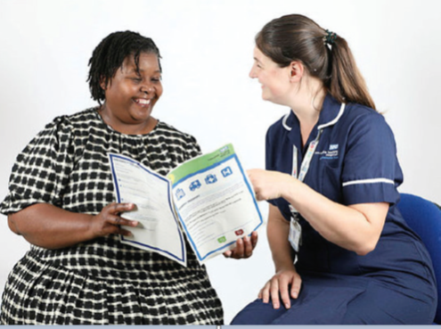 female nurse with femaile patient looking at a leaflet