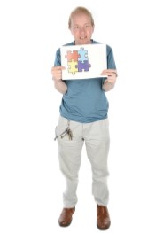 man holding a jigsaw logo