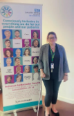 A person by a pull up banner