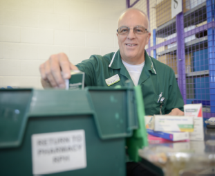 man organising medicines