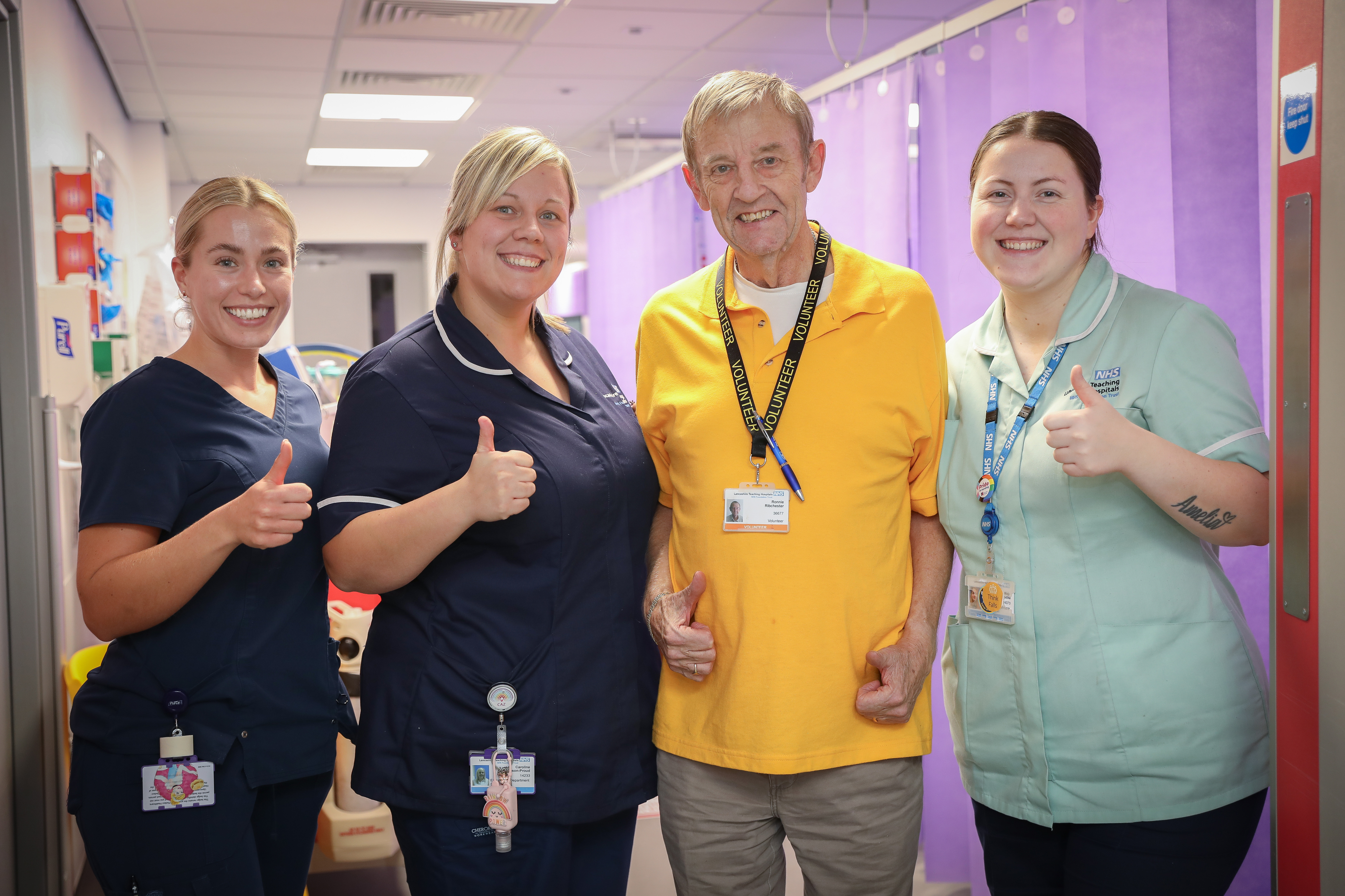 photo of volunteer and three medical staff members smiling for group photo