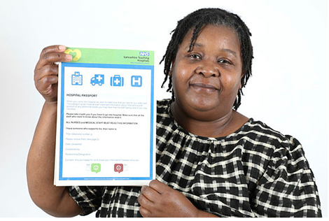 A photo depicting a woman holding a printed out A4 version of the Hospital Passport