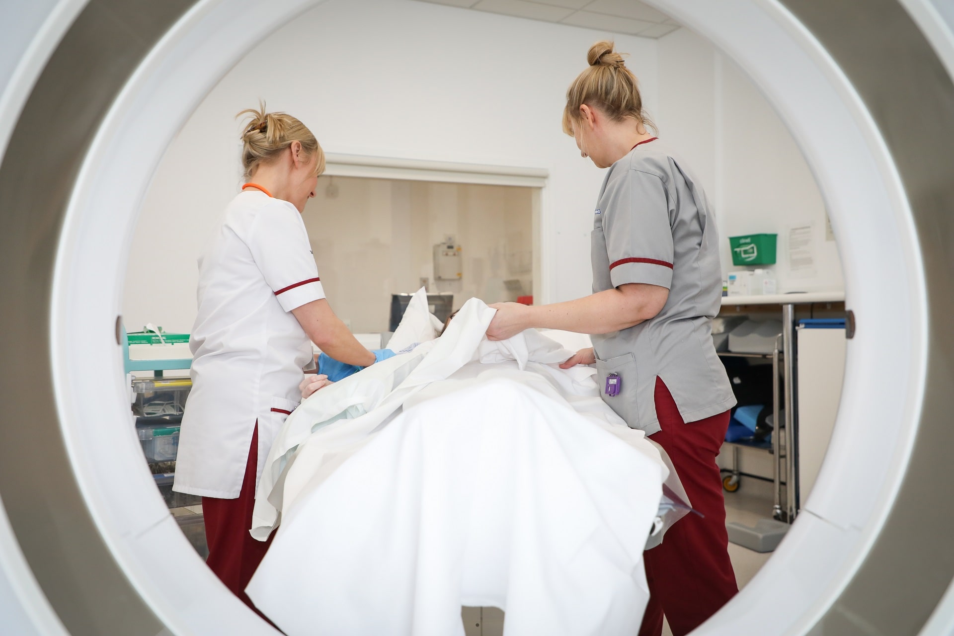 Photo of two female staff members working on patient